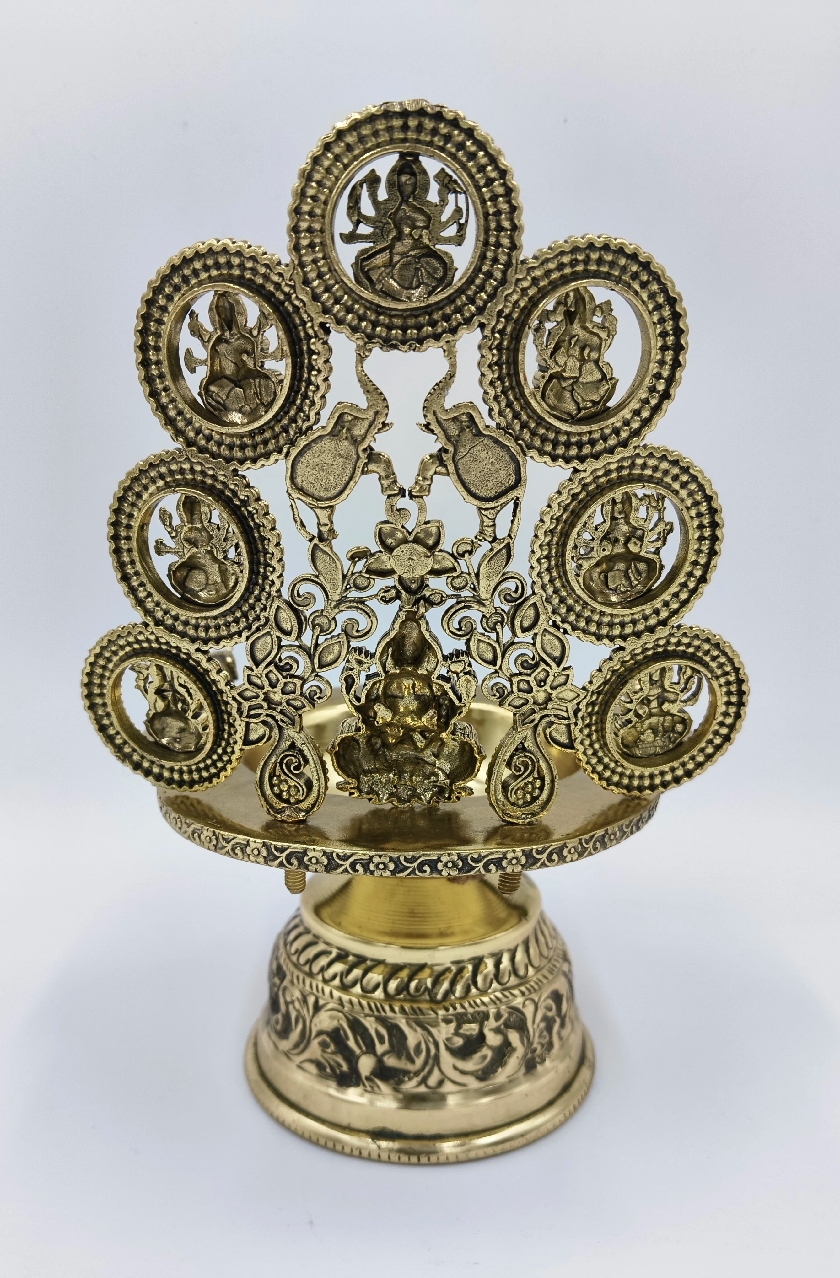 large brass Astalakshmi lamp with detailed deity figures and floral engravings