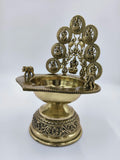 brass Astalakshmi lamp with detailed deity figures and elephant accents