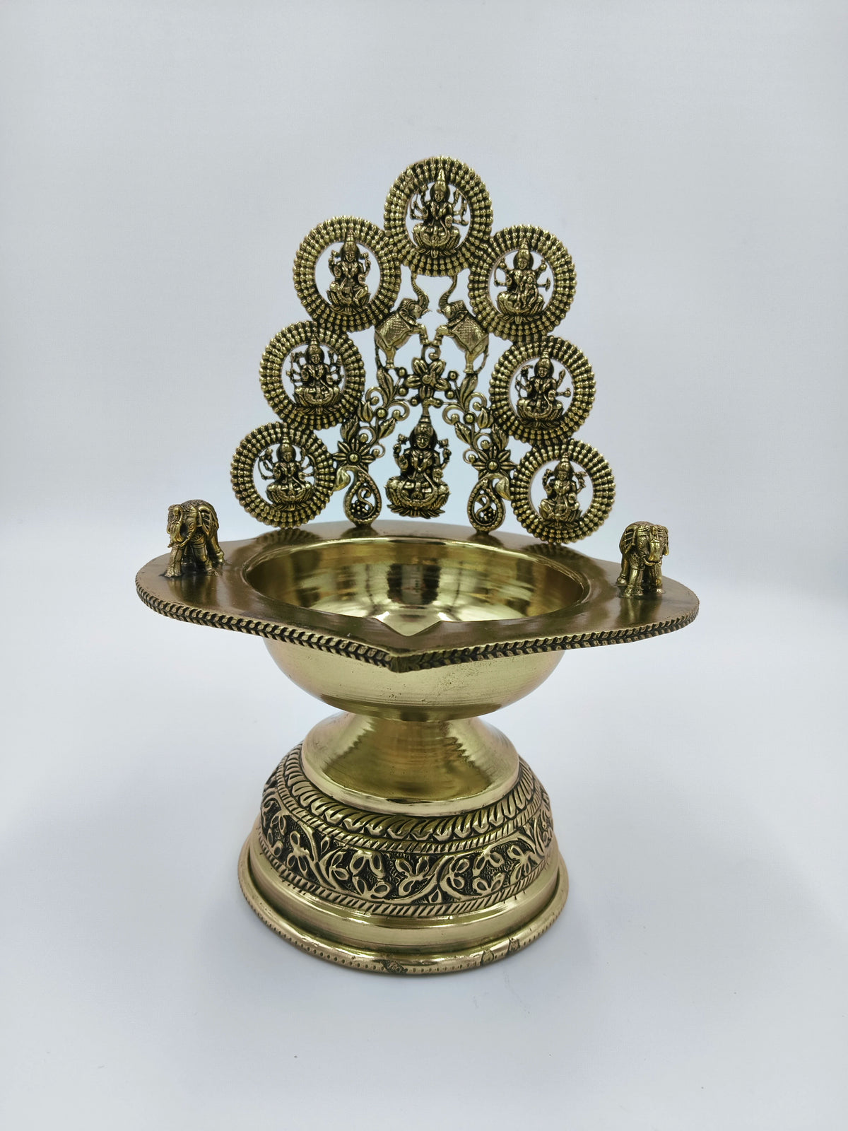Brass Astalakshmi lamp with intricate deity figures and decorative elephants