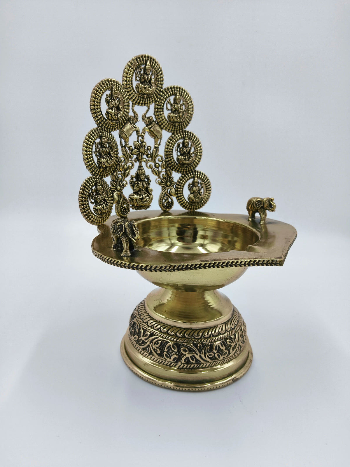 Brass Astalakshmi lamp with detailed goddess figures and elephant accents