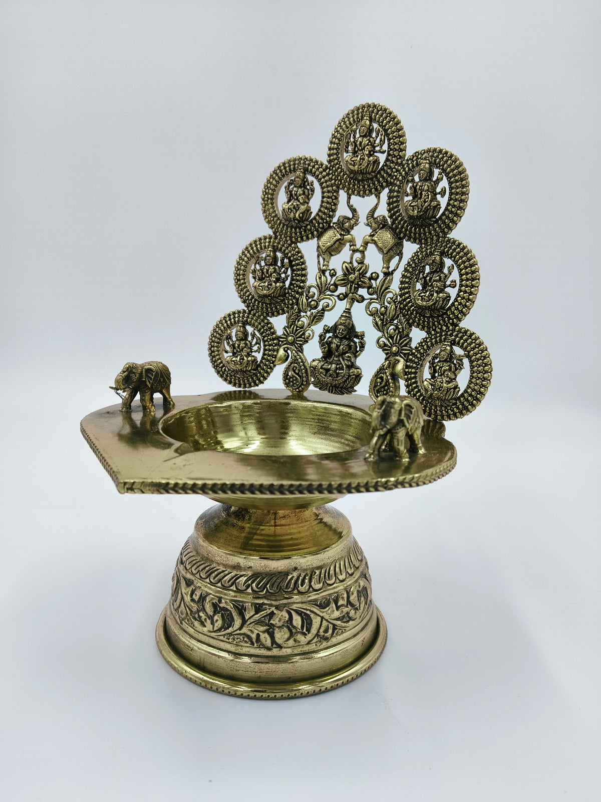 Brass Astalakshmi lamp with detailed goddess figurines and elephant accents