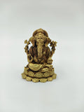 Mini brass Ganesh idol seated on lotus base with detailed ornaments
