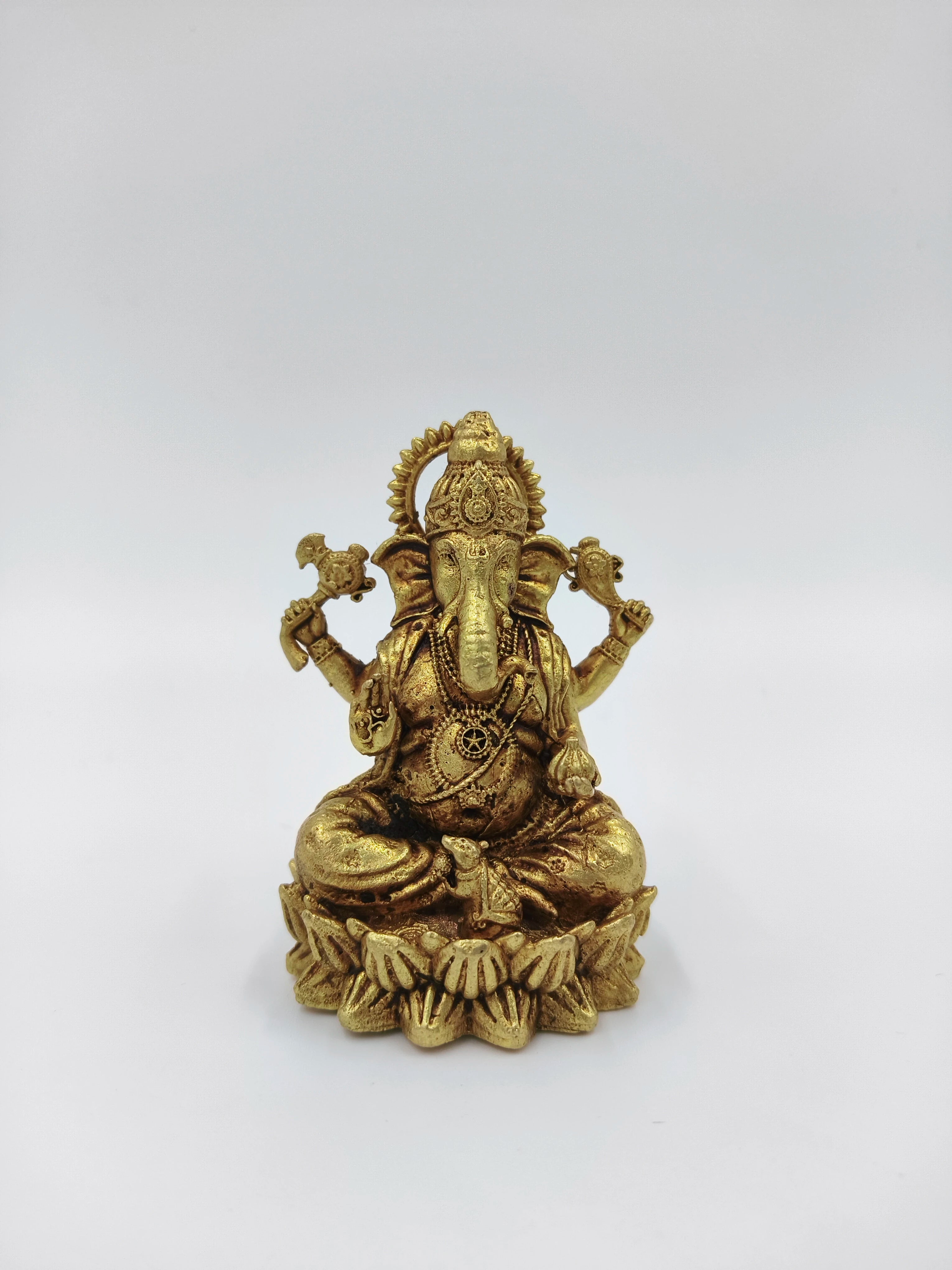 Small brass statue of Vakratunda Ganesh seated on lotus pedestal