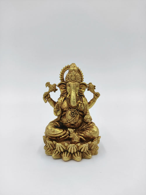 Small brass statue of Vakratunda Ganesh seated on lotus pedestal