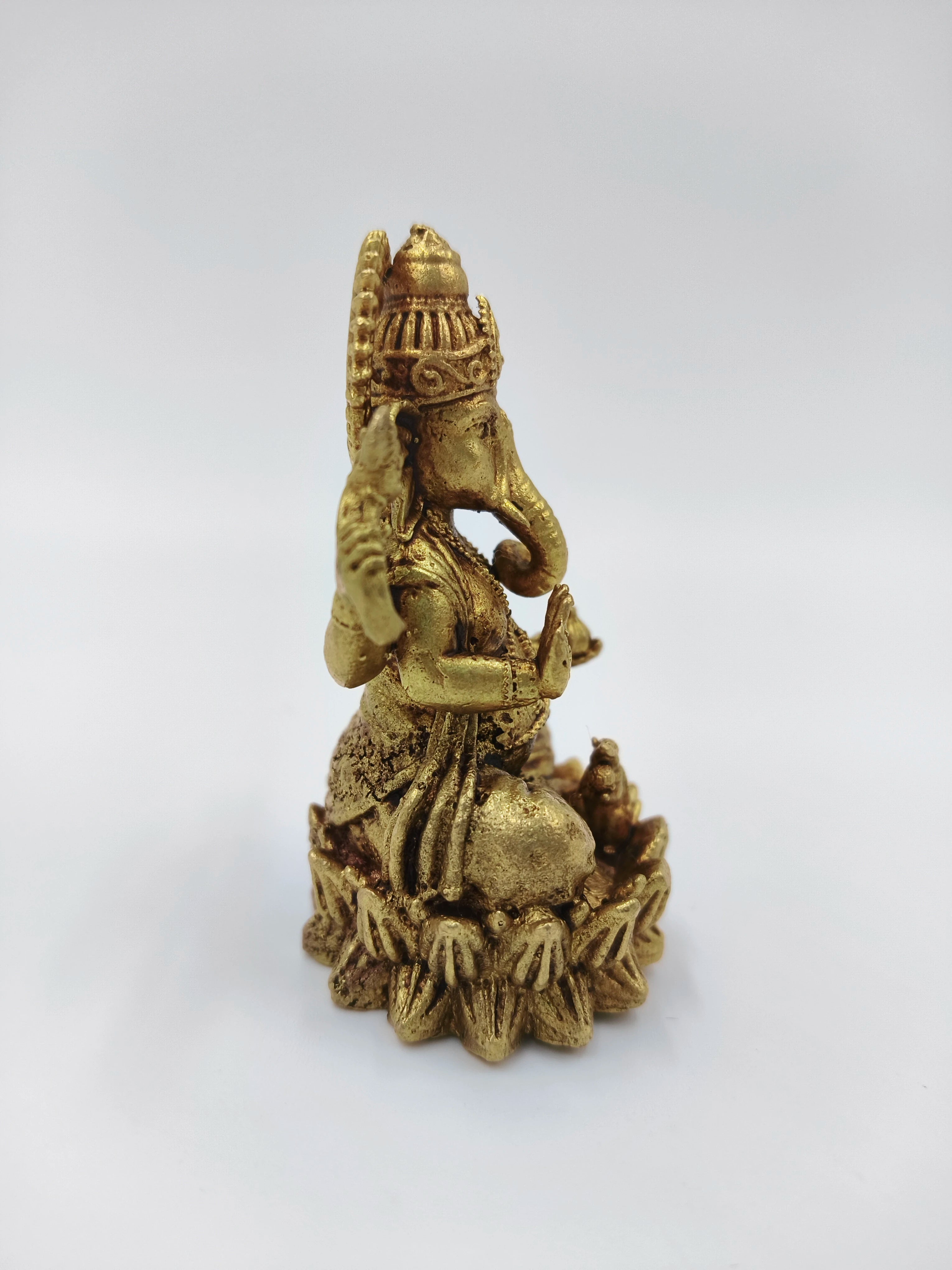 Small brass Vakratunda Ganesh statue seated with intricate detailing
