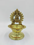 Brass lamp with detailed Ganesh idol and ornate decorative base