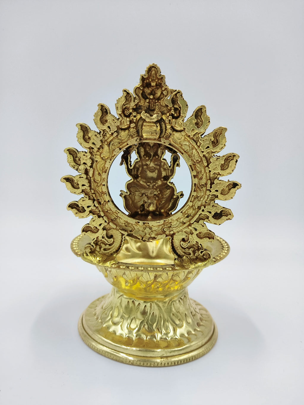 Front view of medium brass Ganesh lamp with decorative circular frame