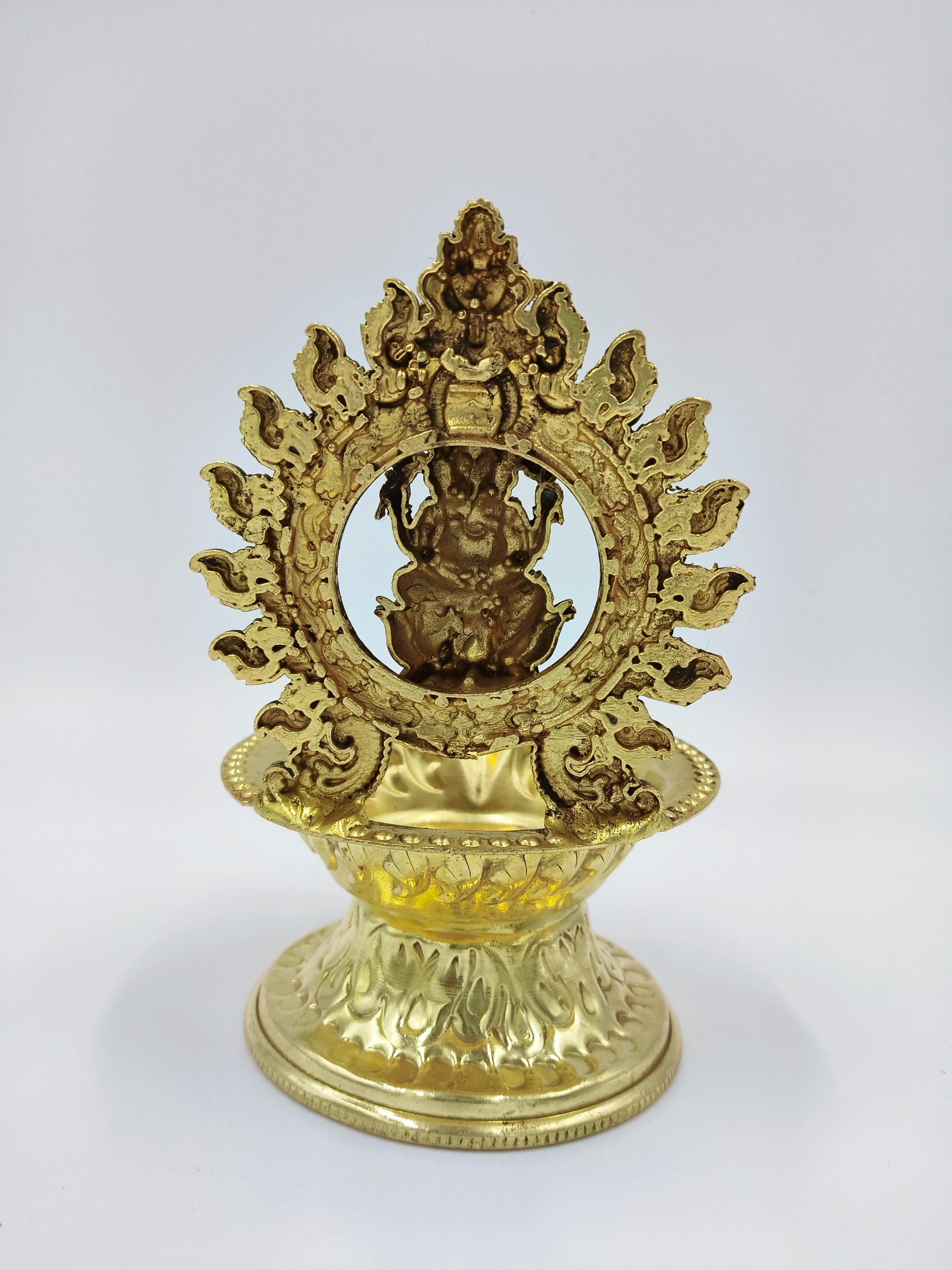 Front view of medium brass Ganesh lamp with decorative circular frame