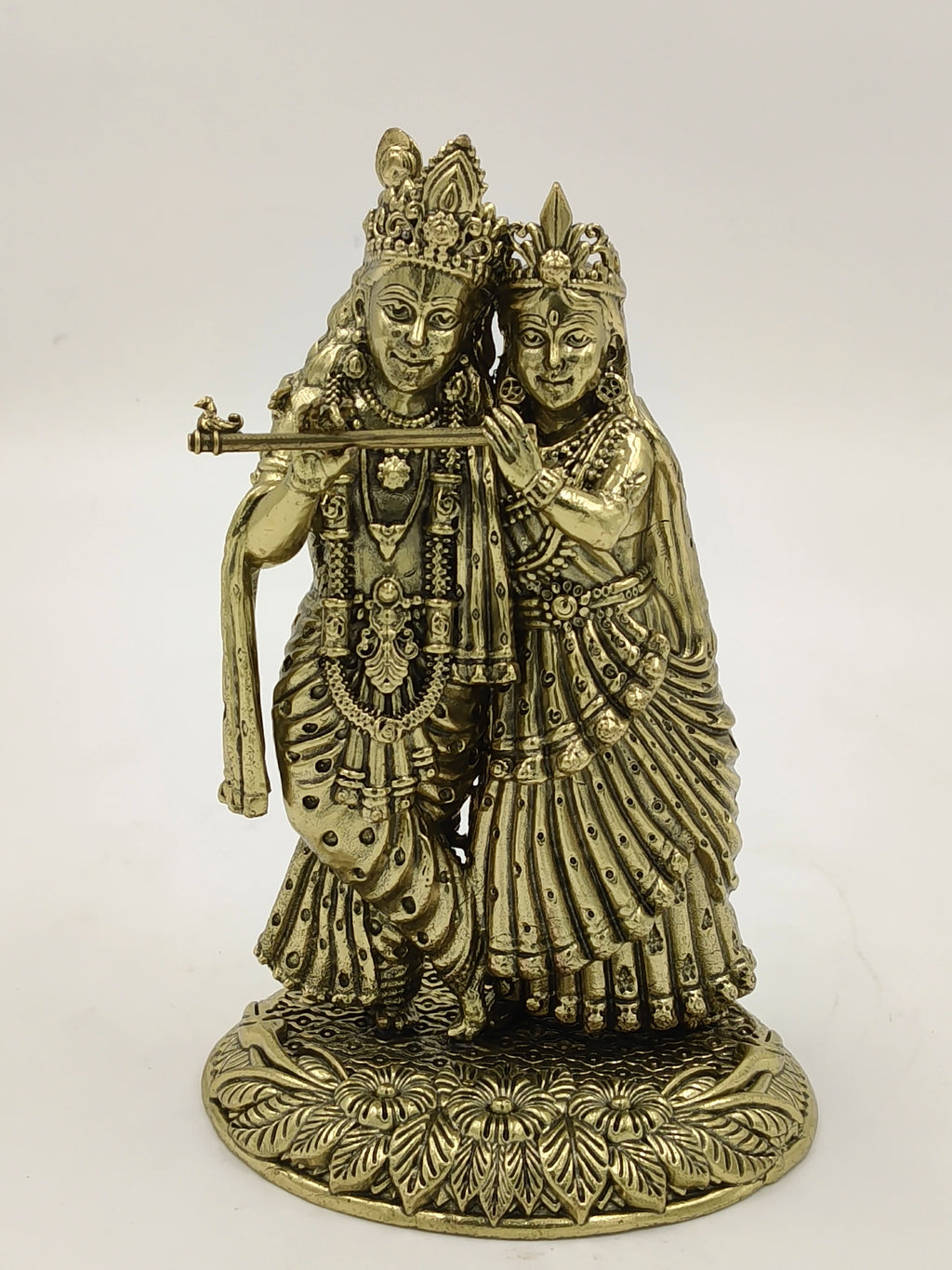 Brass sculpture of Radhakrishna with intricate detailing on a decorative base