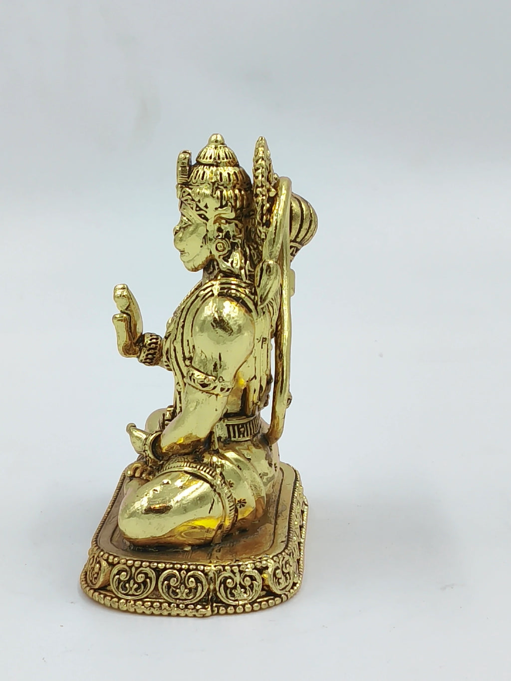 Small brass statue of Hanuman kneeling on ornate base side view