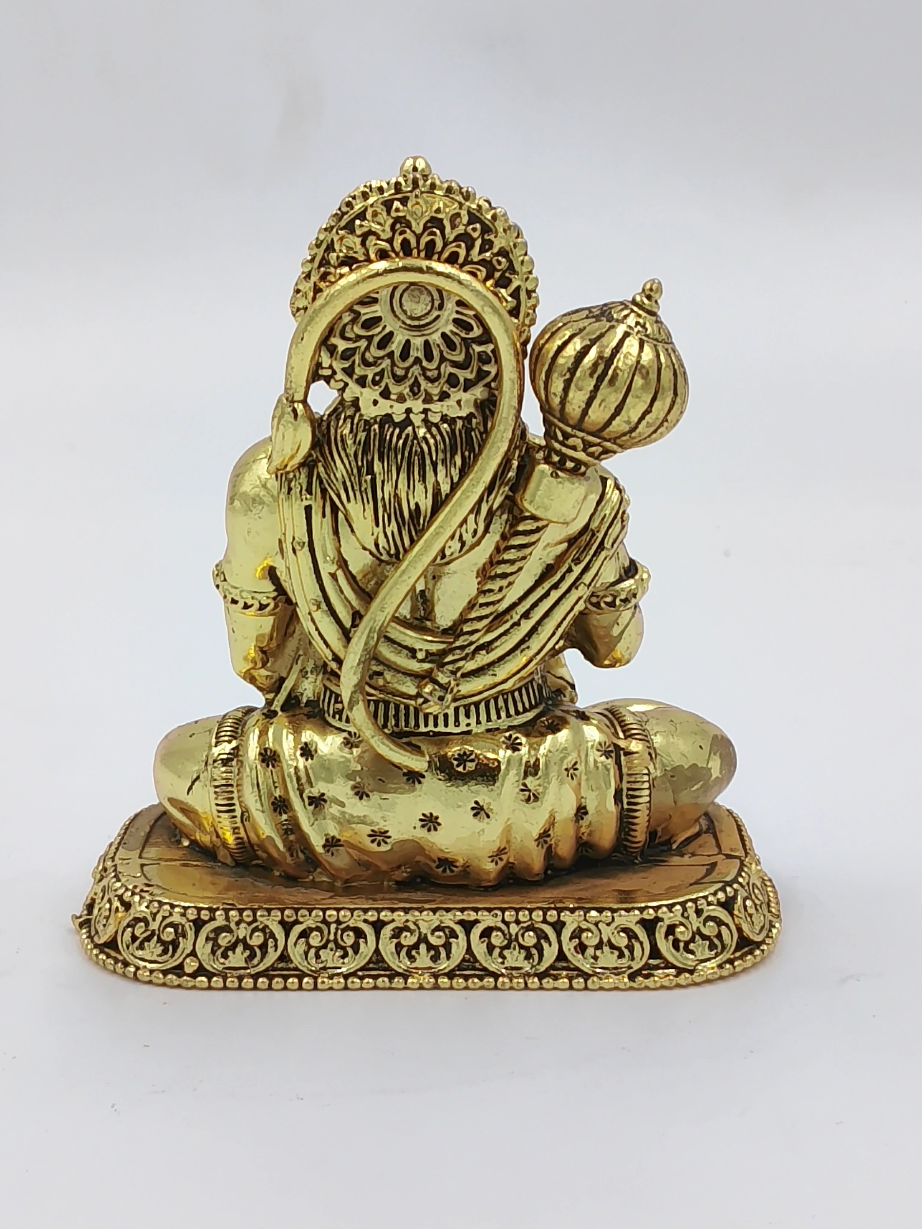 Small brass Hanuman sculpture shown from the back, seated on ornate base