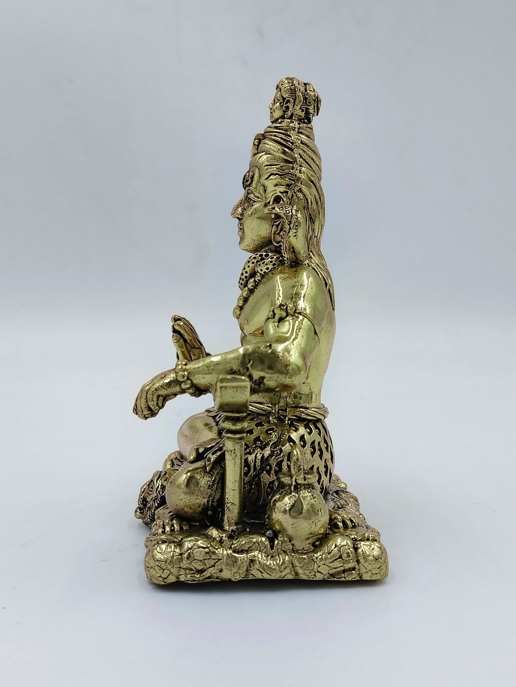 Side view of medium brass Sadashiva statue depicting Lord Shiva seated
