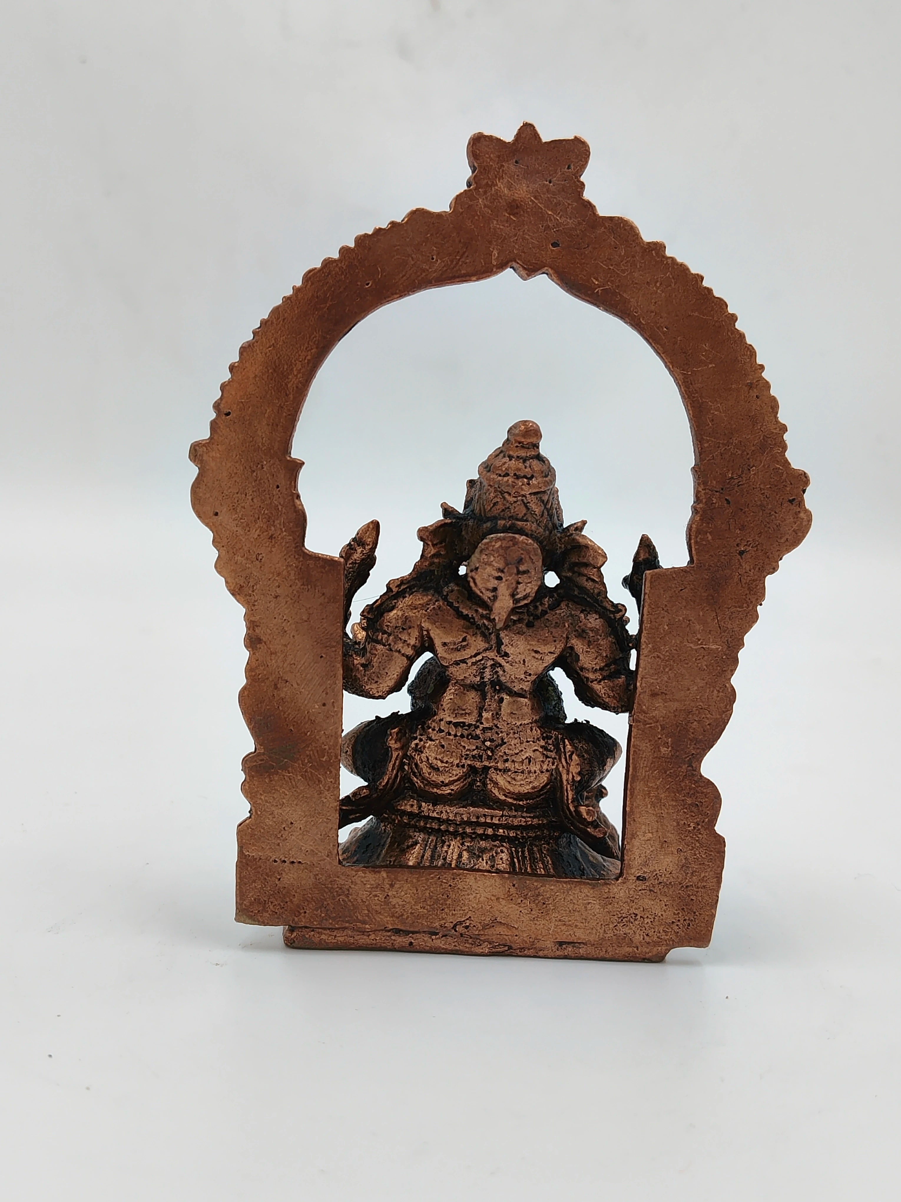 Small brass Ganesh statue with decorative arch frame back view