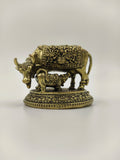 Mini brass sculpture of a cow and calf with detailed ornamental design