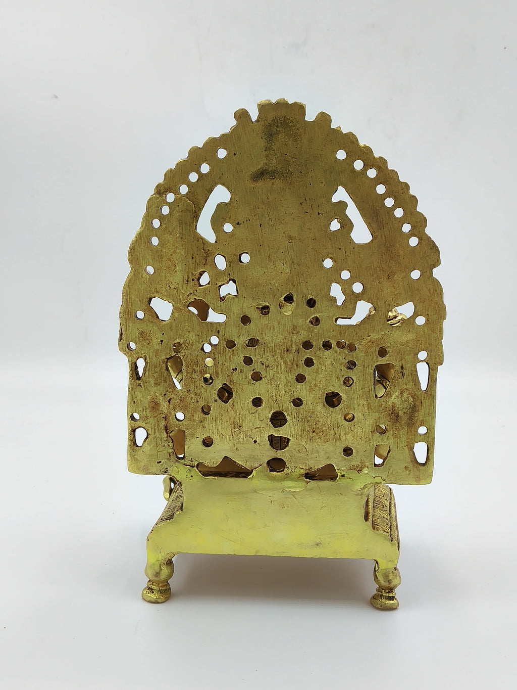 Back view of large brass Ganesh statue with intricate cutout design