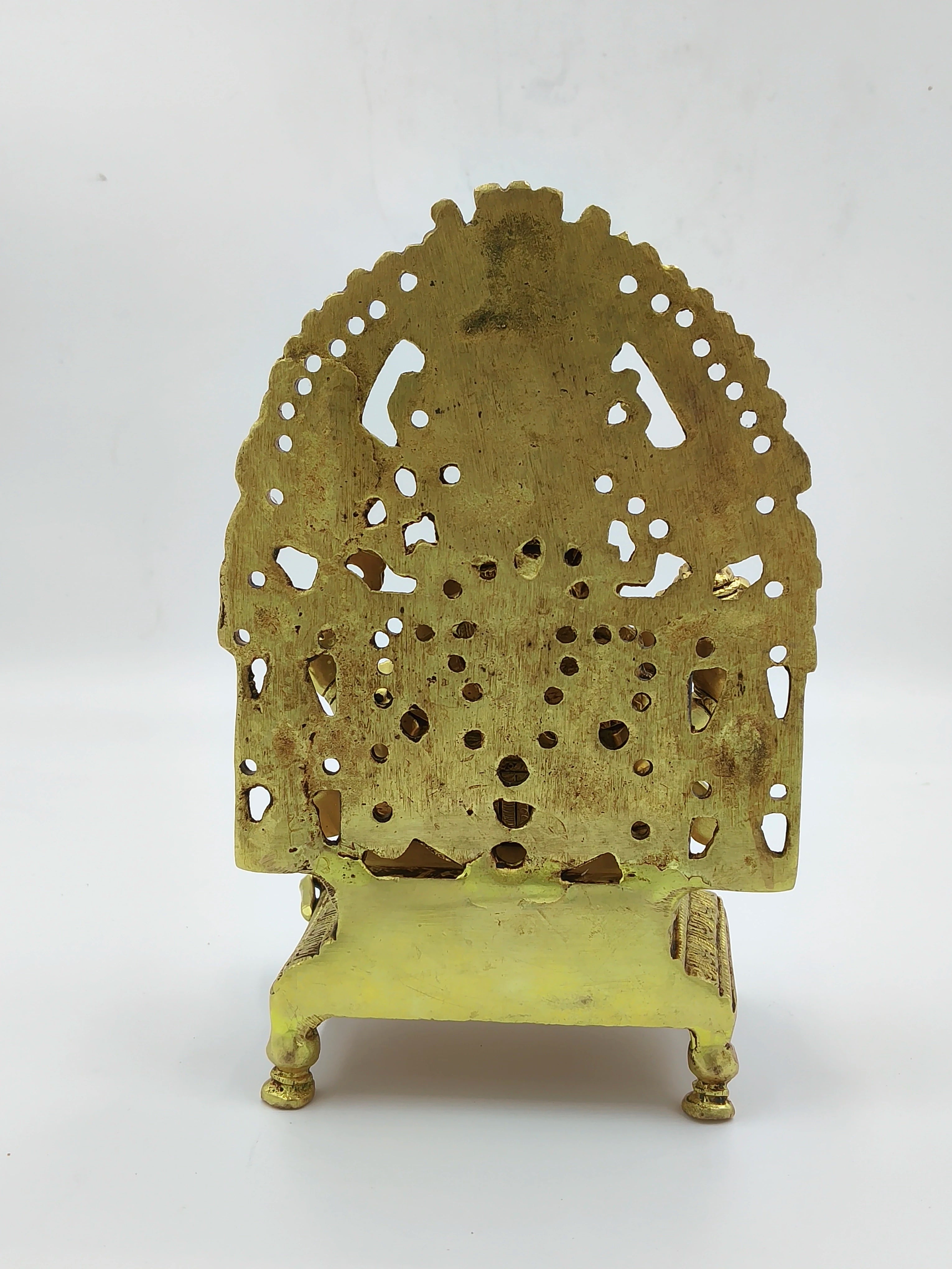Back view of large brass Ganesh statue with intricate cutout design