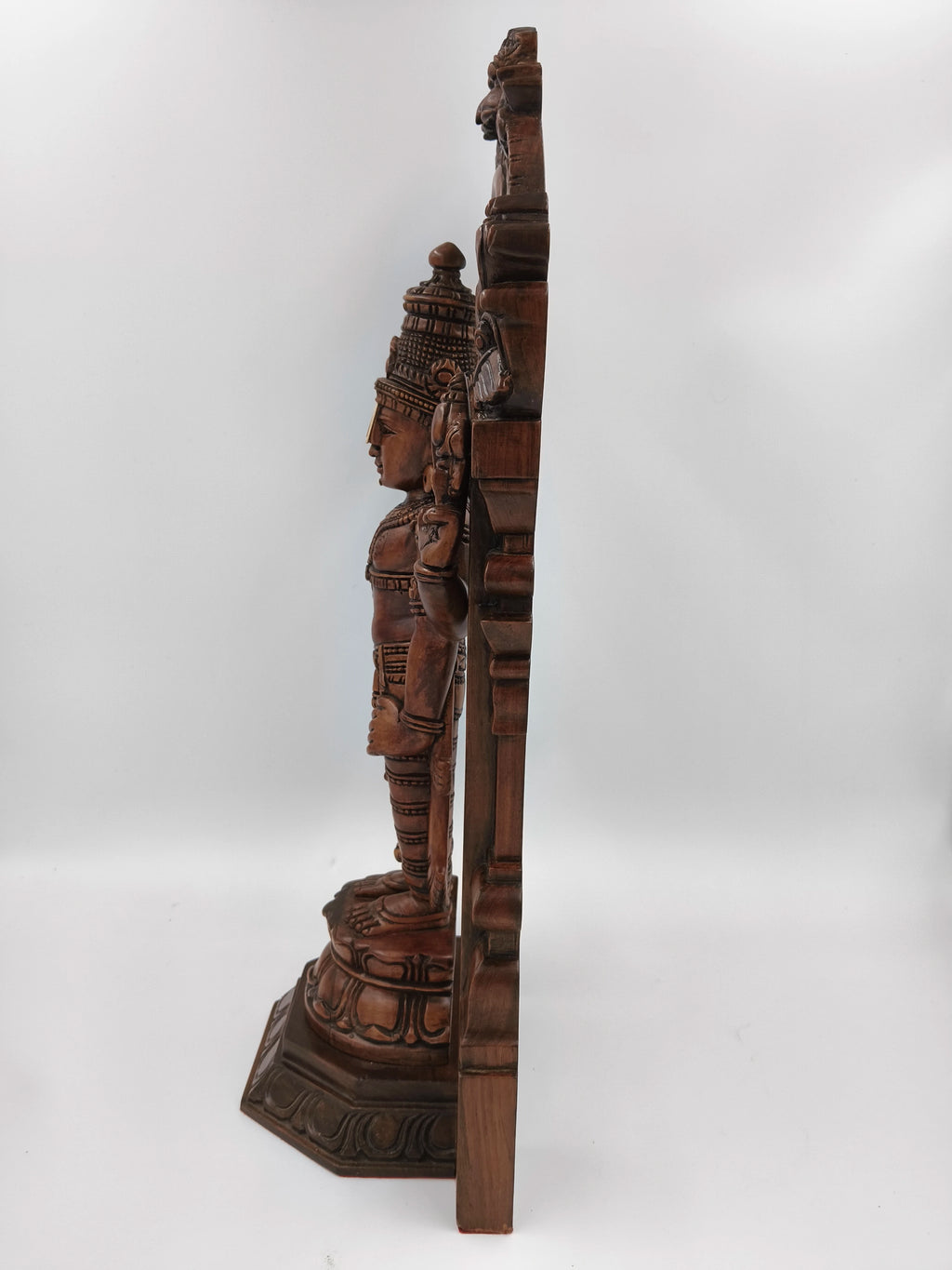 Side view of large teakwood Arch Balaji standing statue with detailed carvings