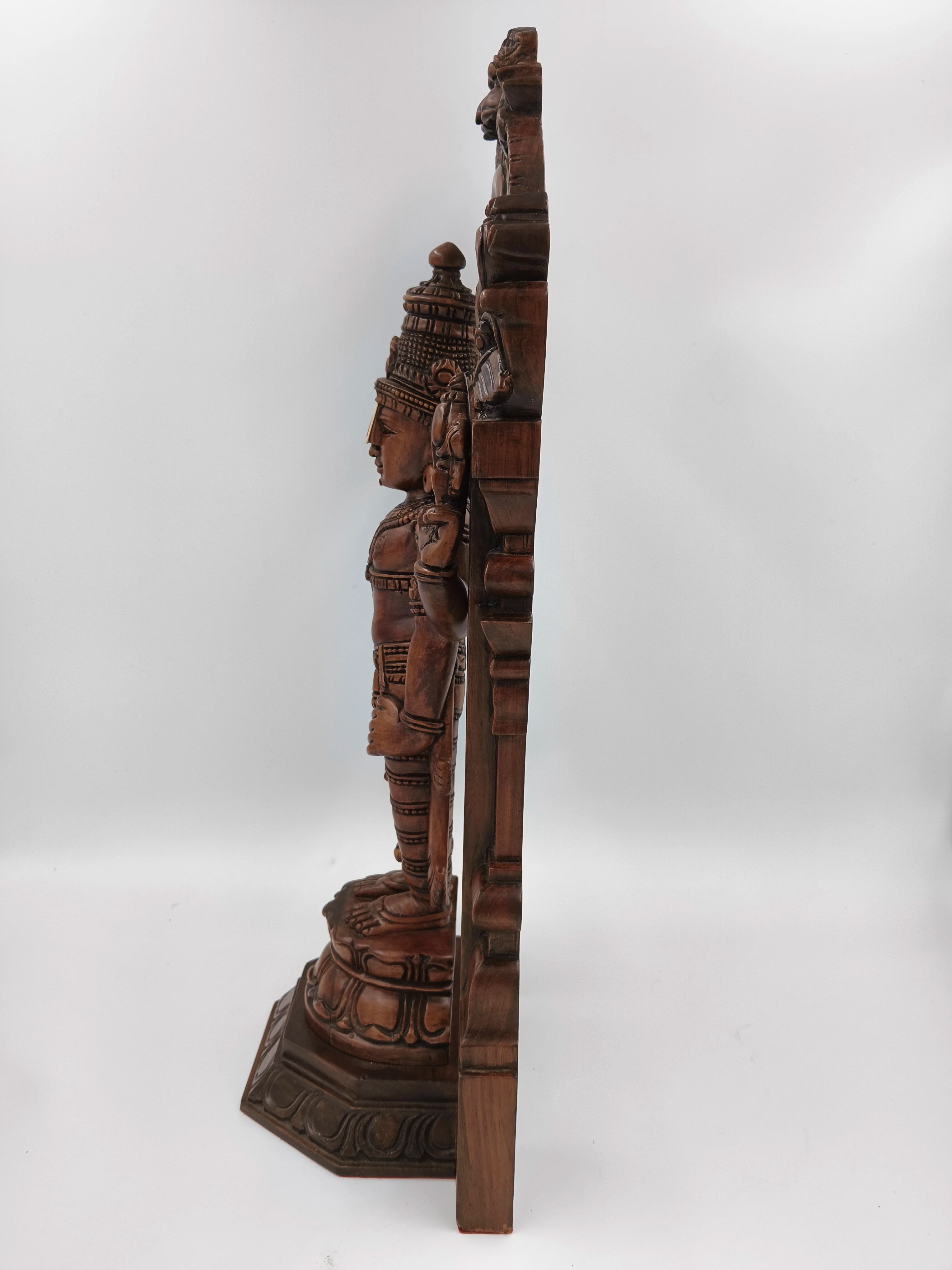 Side view of large teakwood Arch Balaji standing statue with detailed carvings