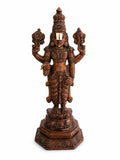 Large teakwood statue of deity Balaji with intricate carvings on ornate base