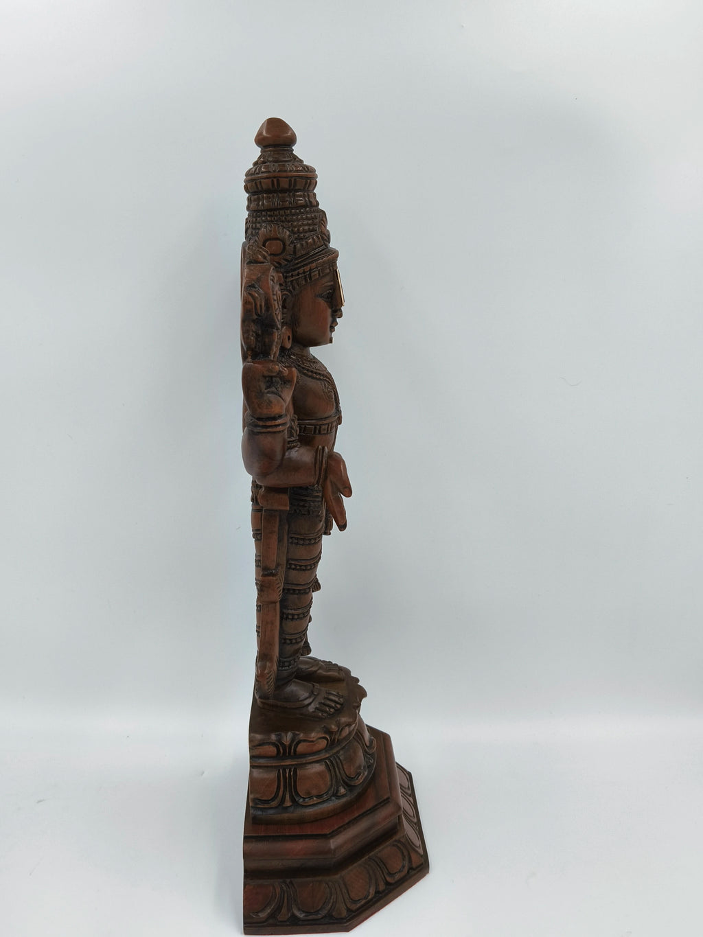 Side view of large teakwood Balaji statue with detailed carvings