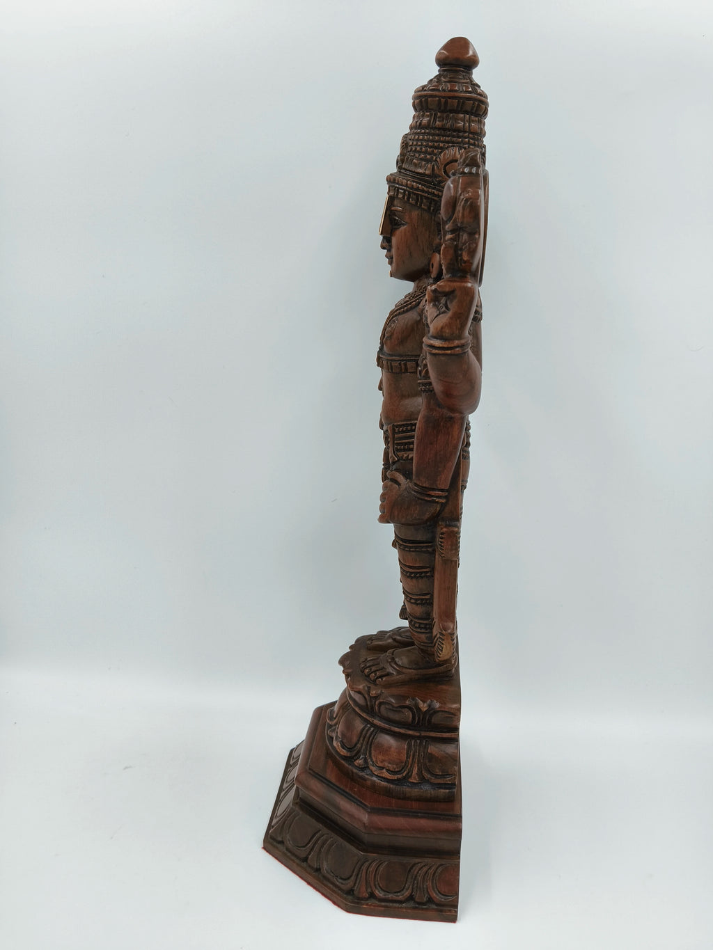Side view of large teakwood Balaji statue with intricate carvings
