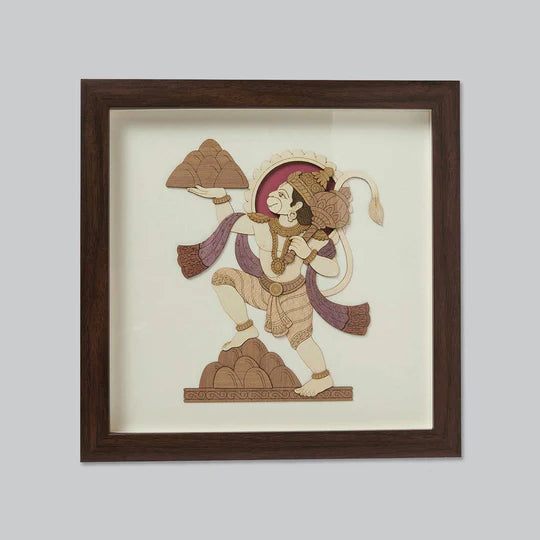 Wooden framed art piece depicting Hanuman carrying mountains in traditional style