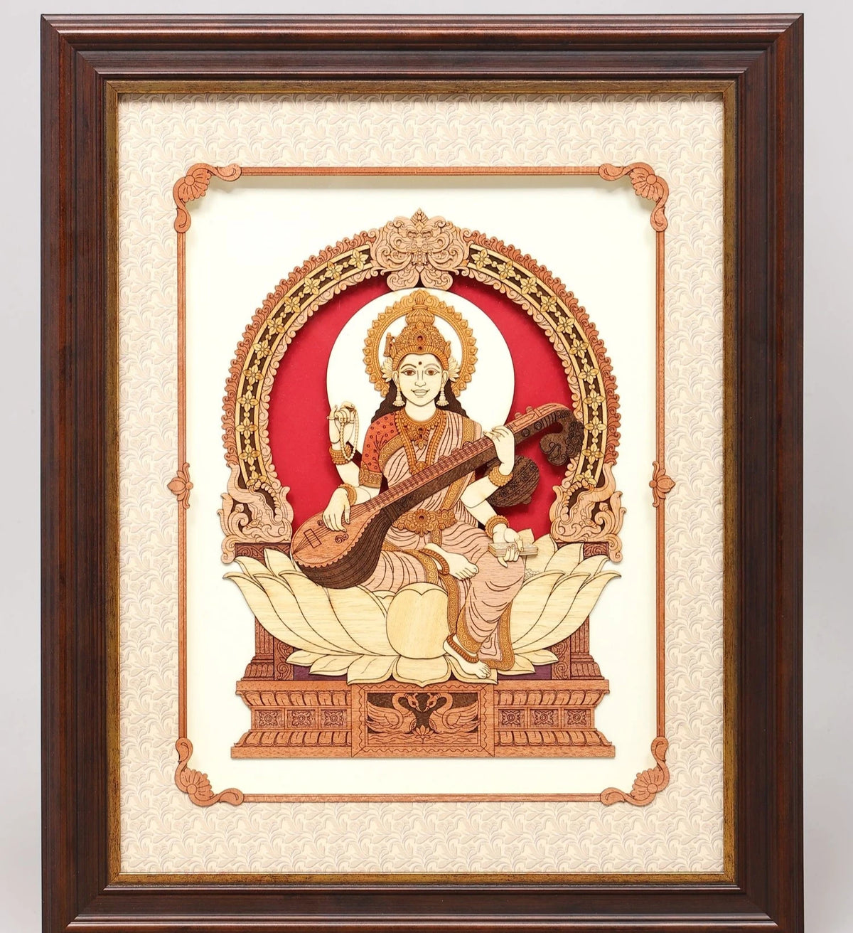 Large wooden wall art depicting Saraswathi seated on a lotus with veena