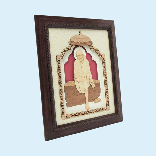 Wooden framed art of Shirdi Baba sitting under decorated arch