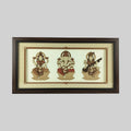 Wood art frame featuring seated Lakshmi, Ganesh, and Saraswathi deities