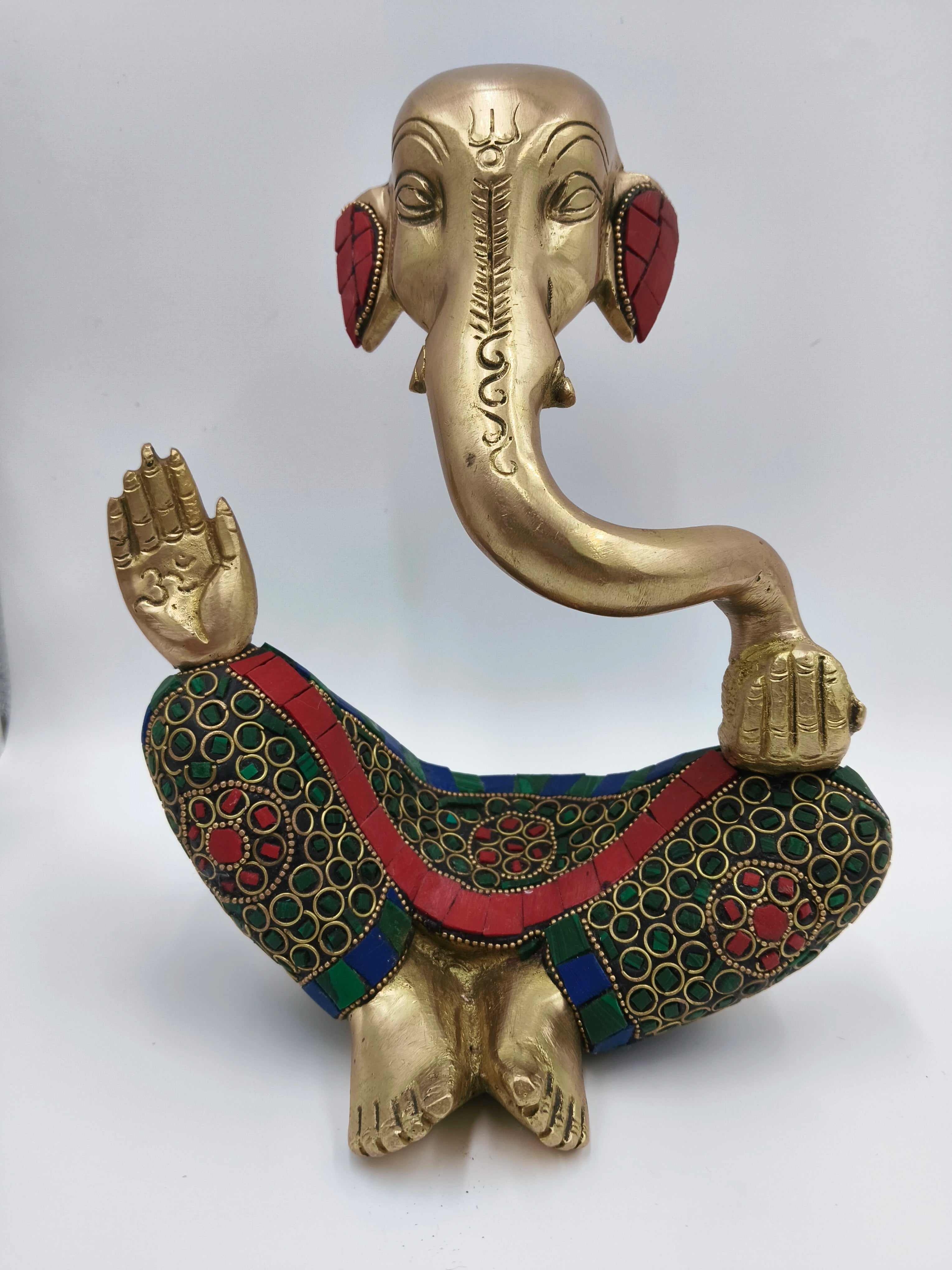 Large brass Ganesha statue seated with colorful patterned clothing details