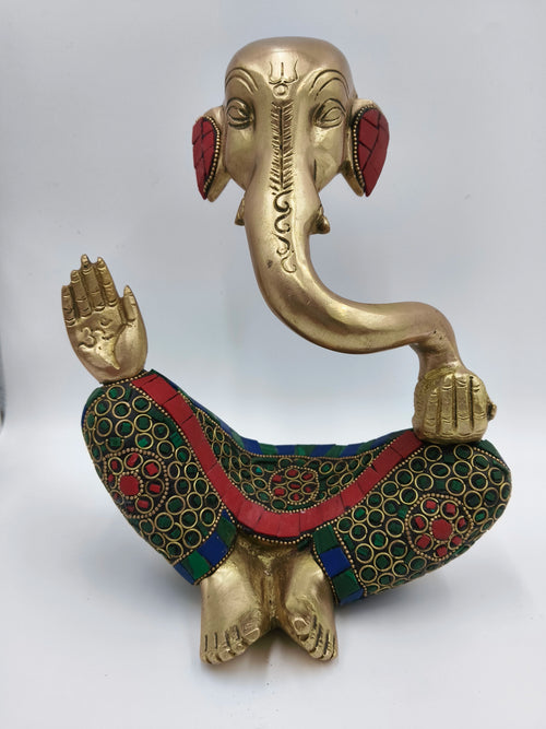 Large brass Ganesha statue seated with colorful patterned clothing details