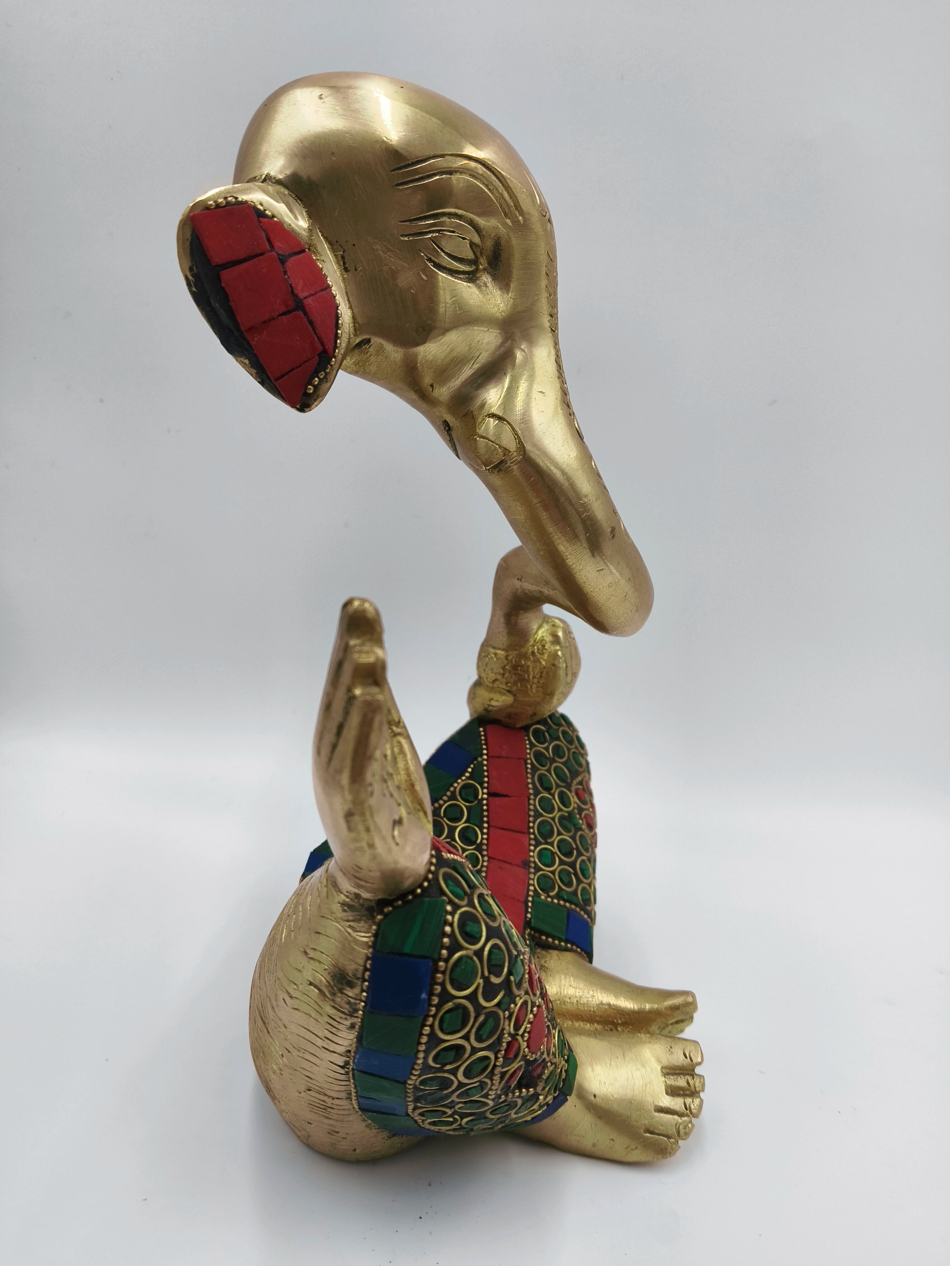 Side view of large brass modern Ganesha statue with colorful inlay decorations