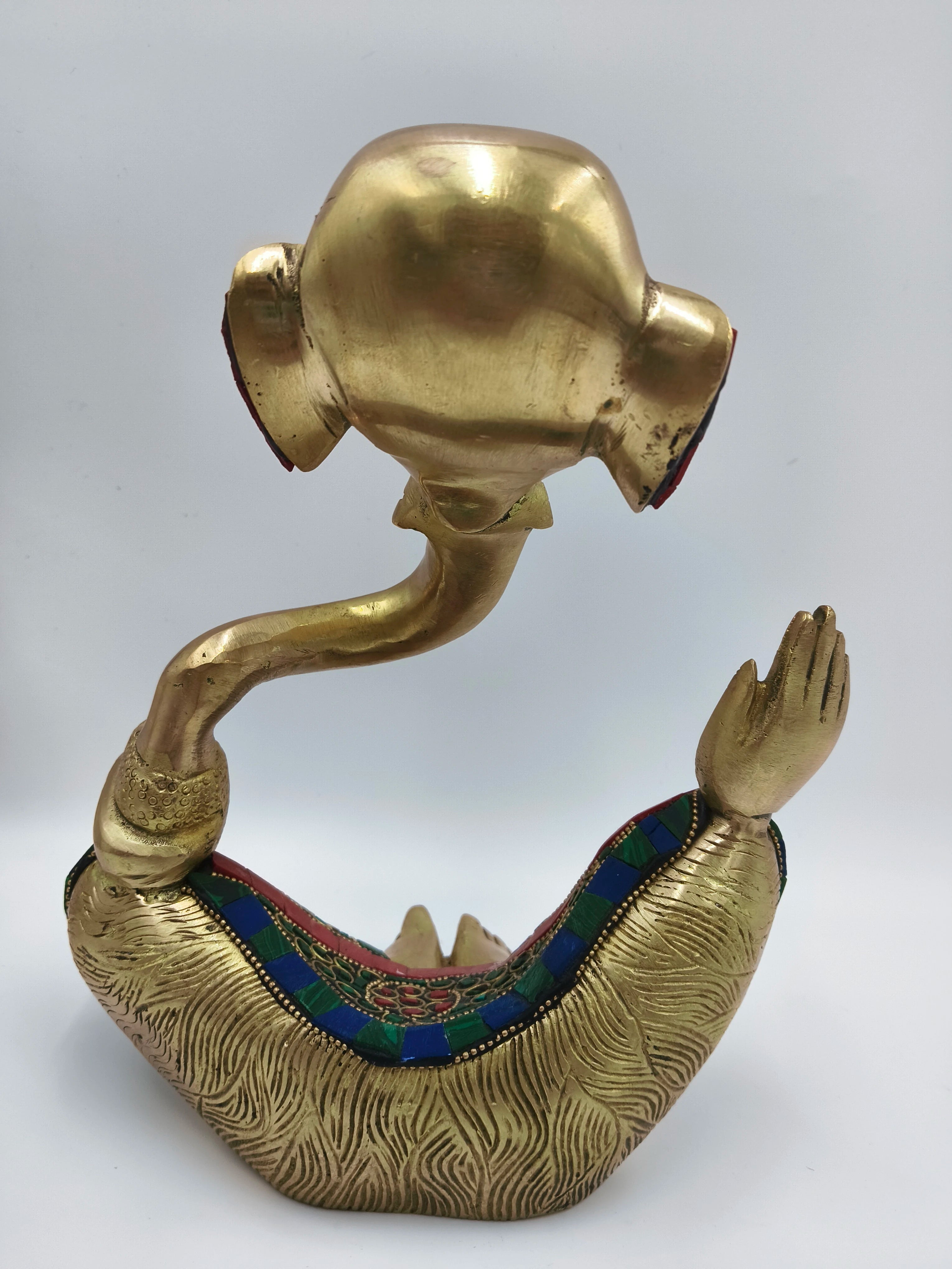 Back view of large brass modern Ganesha statue with decorative engraved patterns