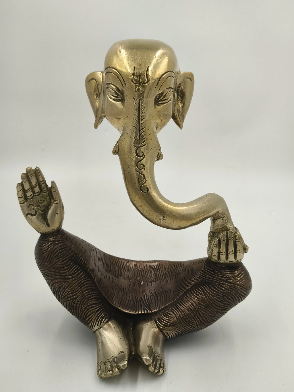 Large brass modern Ganesha statue with raised hand and detailed carving