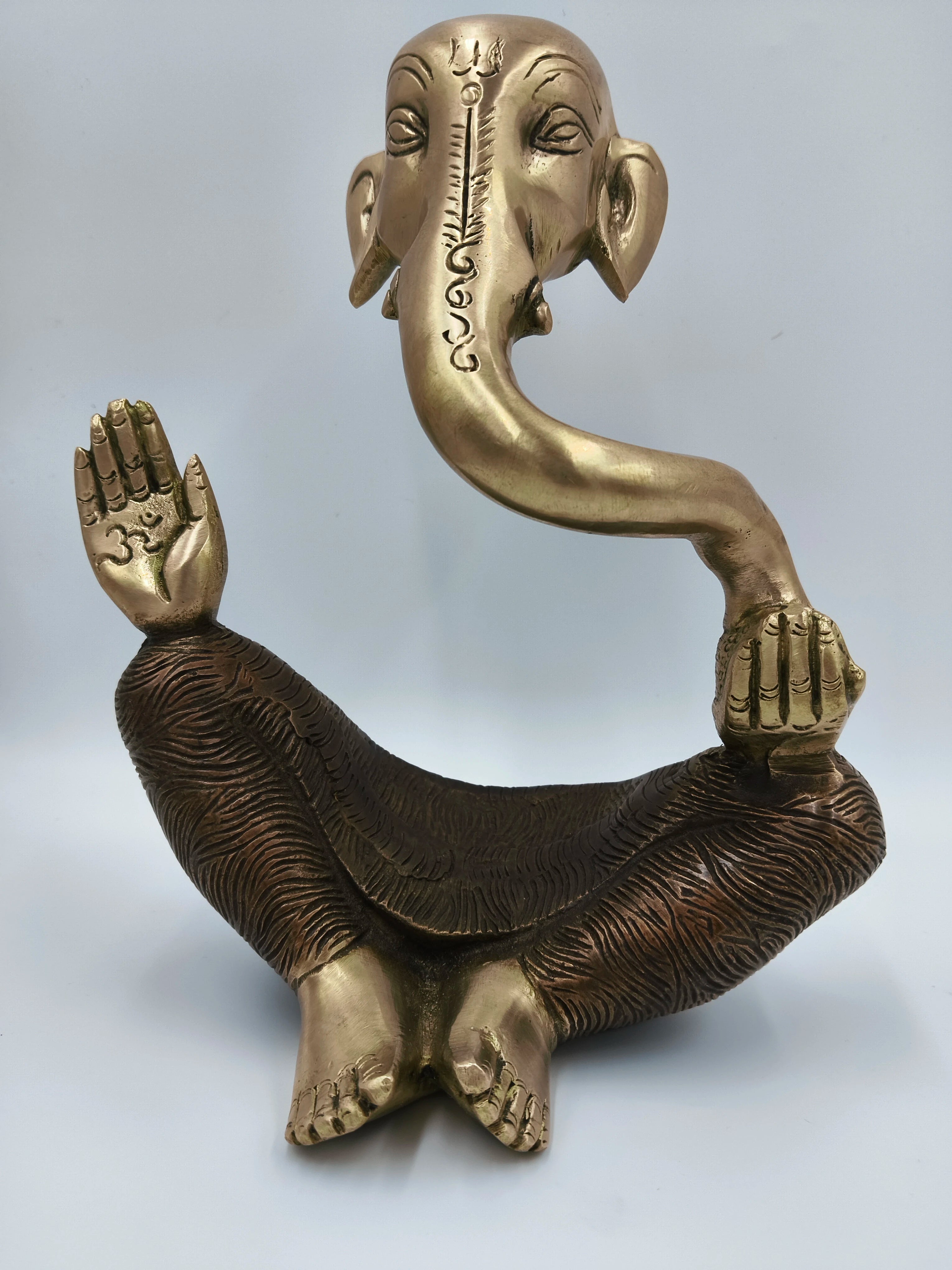 Large modern brass Ganesha statue with seated figure and extended trunk