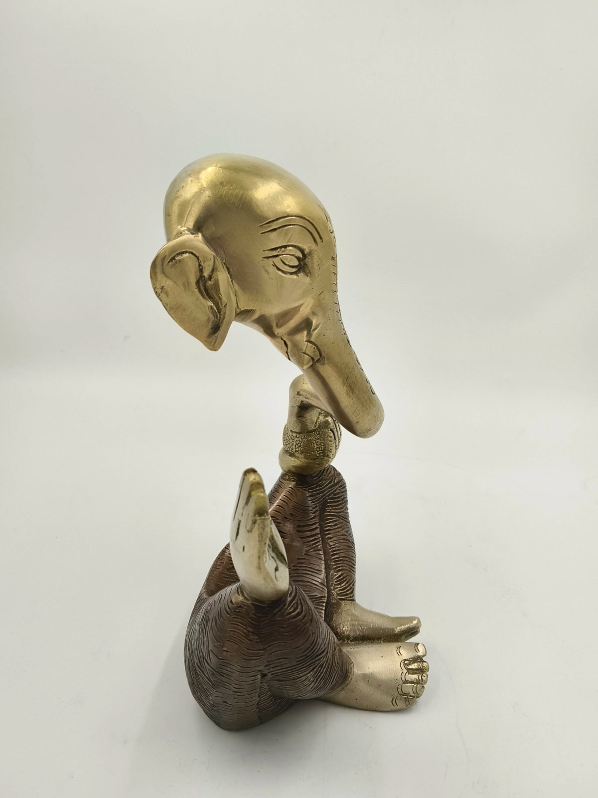 Large modern brass Ganesha statue with seated figure and extended trunk