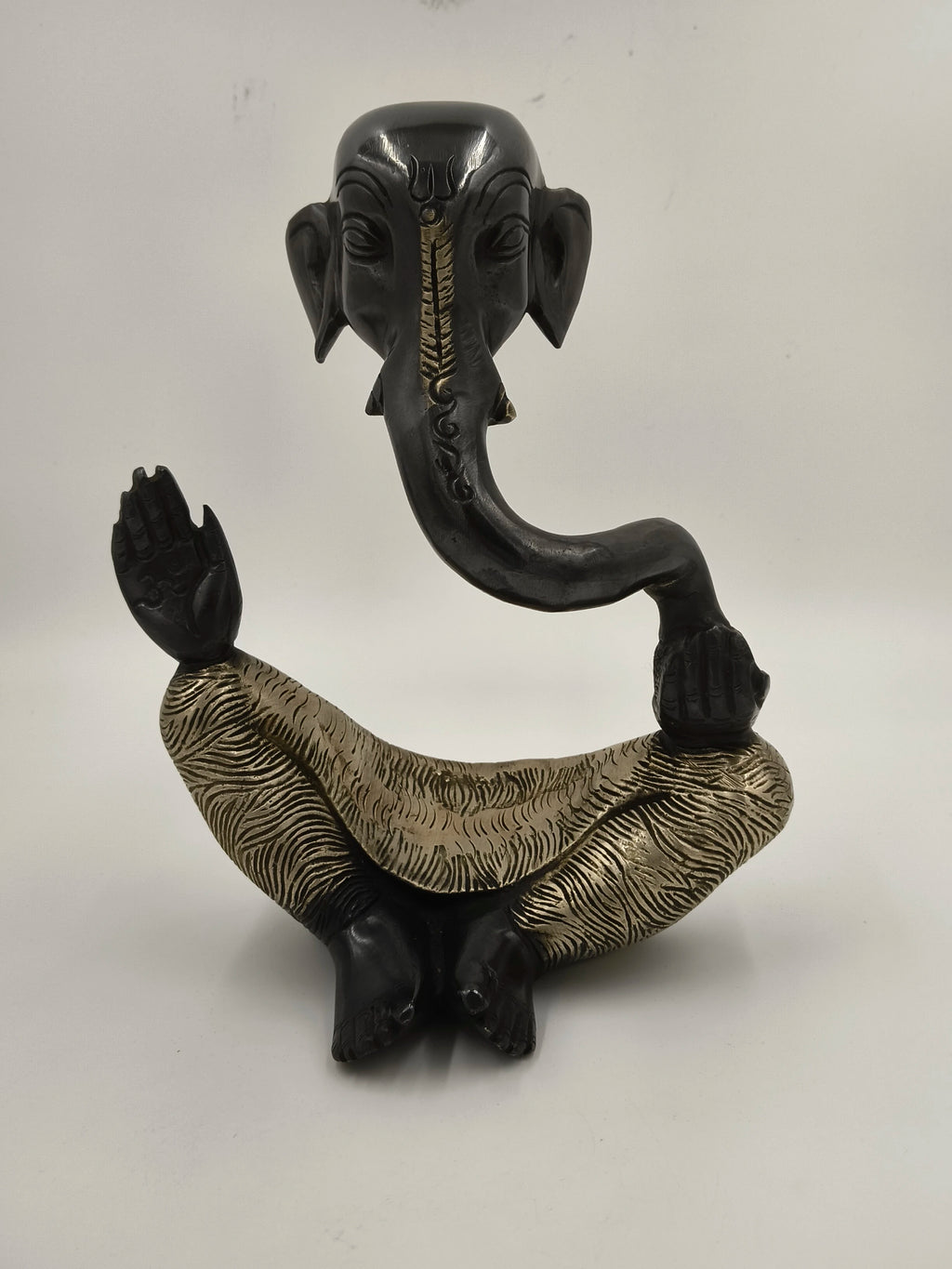 Brass modern Ganesha sculpture in a seated pose with detailed patterns