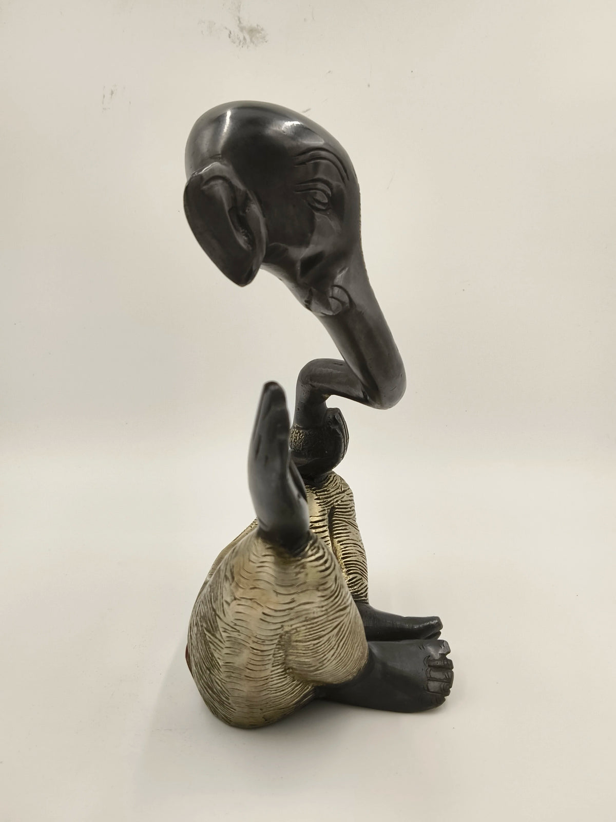 Modern brass sculpture of the deity Ganesha sitting with raised hand
