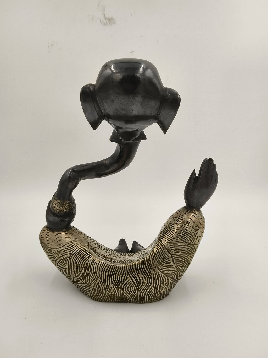 Modern brass sculpture of Ganesh with textured gold and black finish