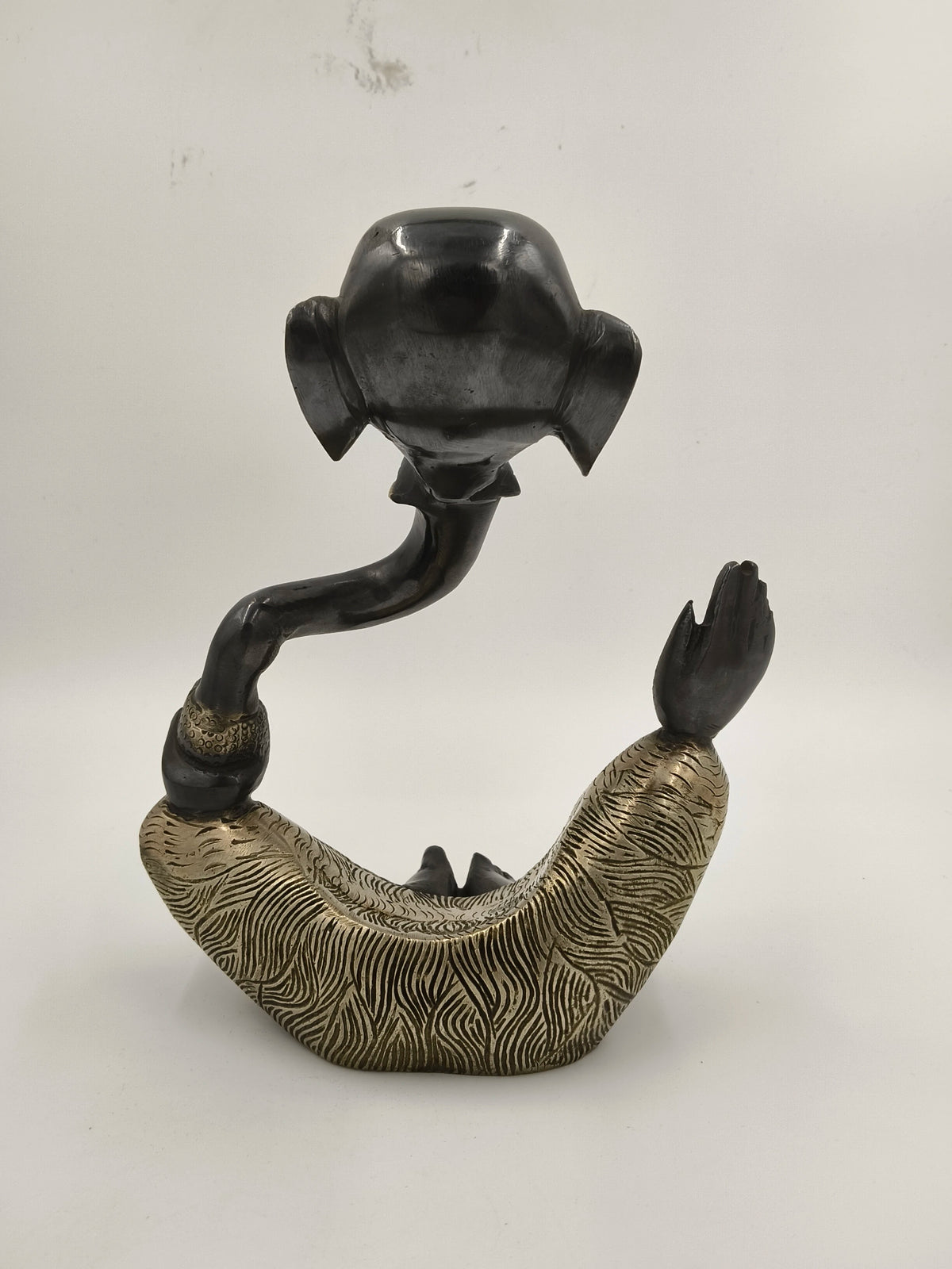 Modern brass sculpture of Ganesh with textured gold and black finish