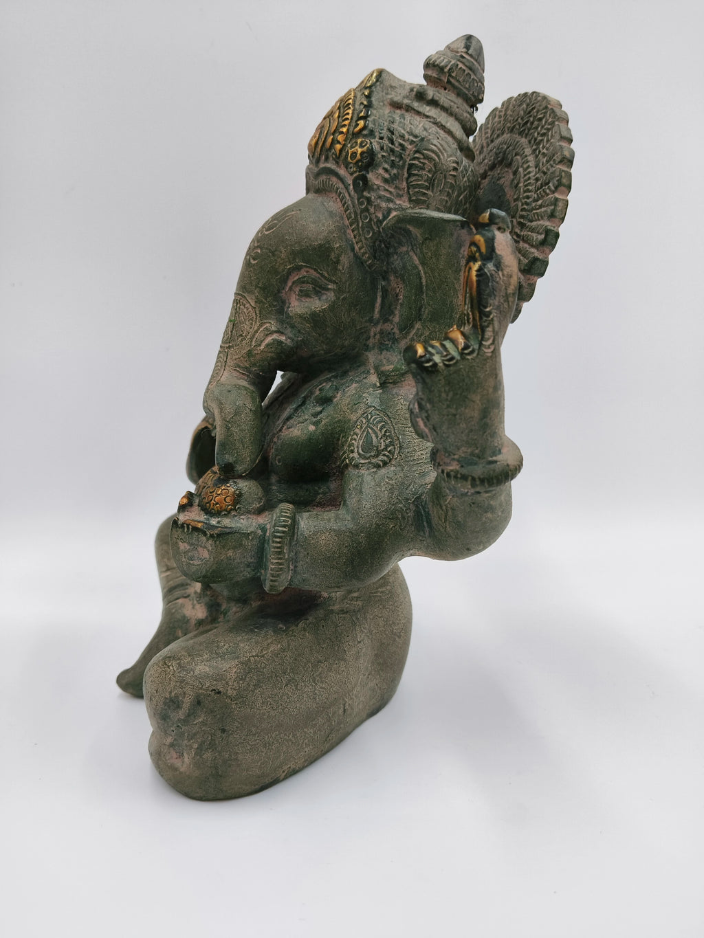 Side view of large brass Appu Ganesha statue with intricate carvings