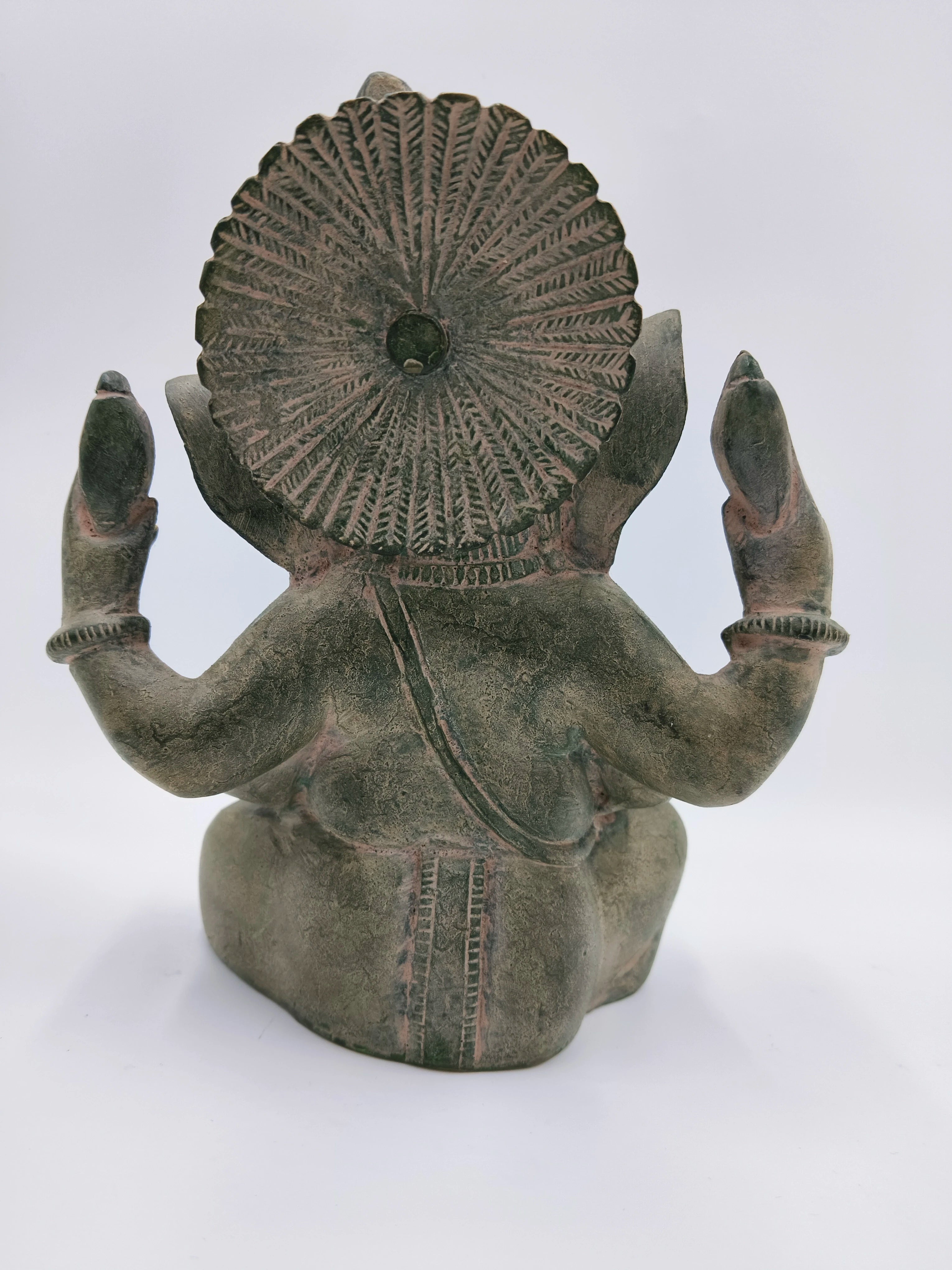 Back view of large brass Appu Ganesha statue with detailed headdress and raised hands