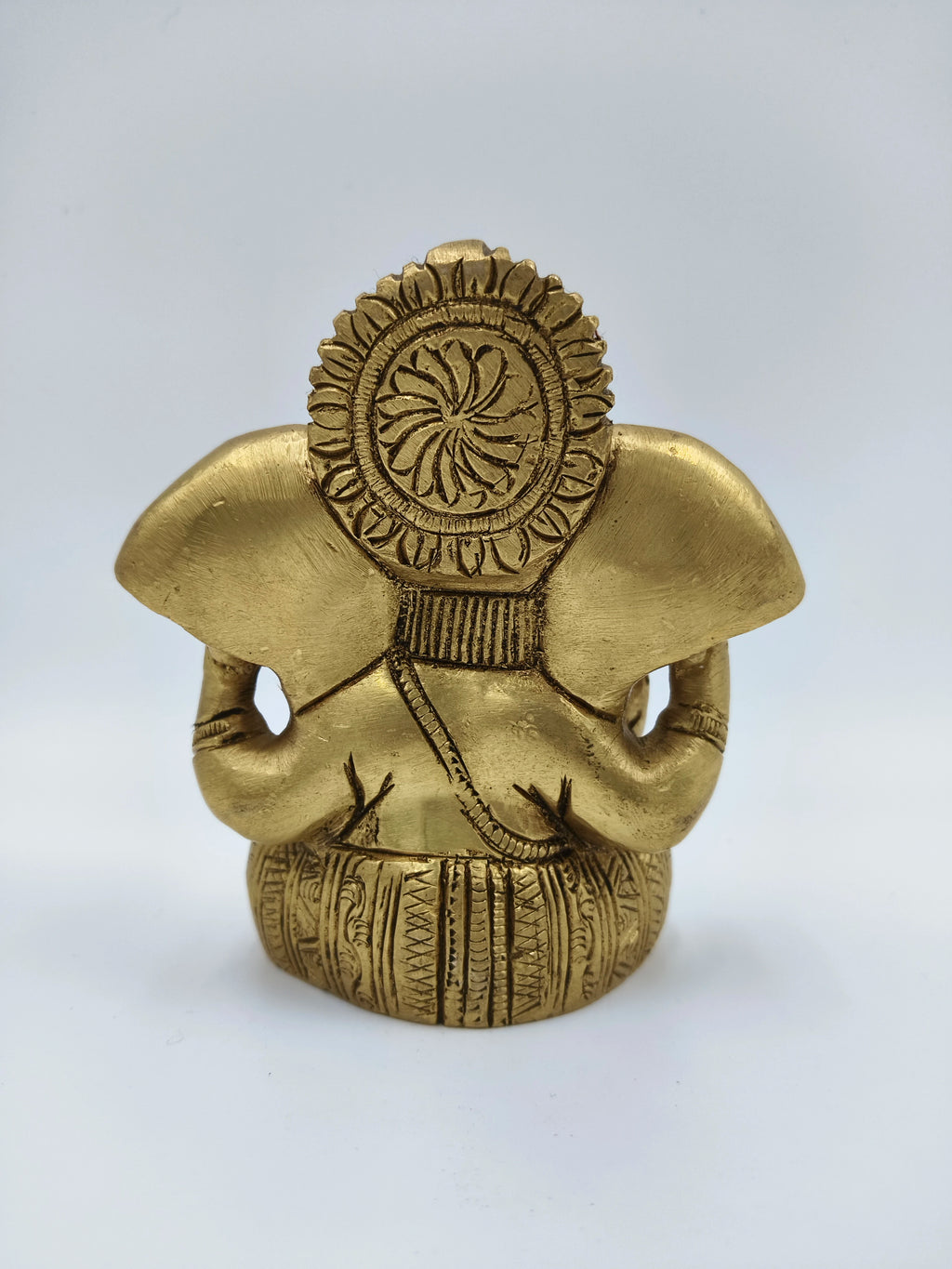 Back view of small brass Appu Ganesha statue with ornate detailing