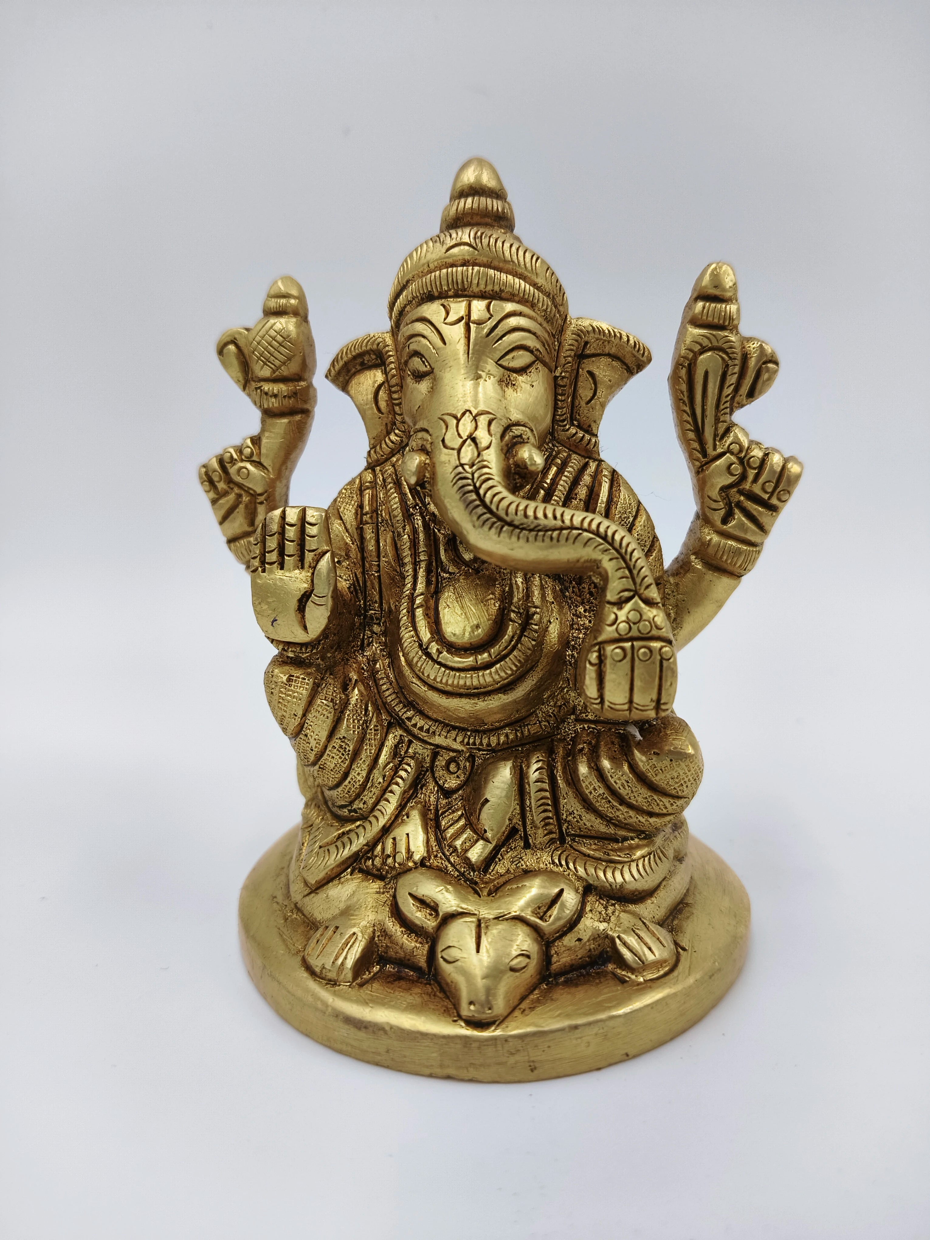 Small brass statue of sitting Lord Ganesha with mouse figure at base