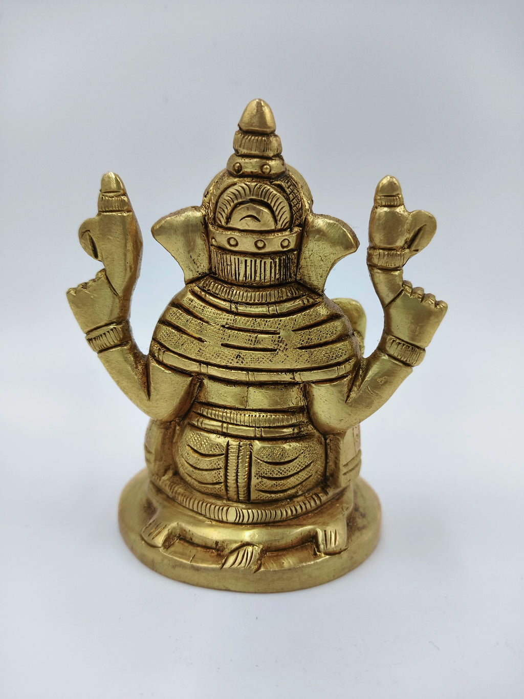 Back view of small brass Sitting Ganesha statue with detailed carvings