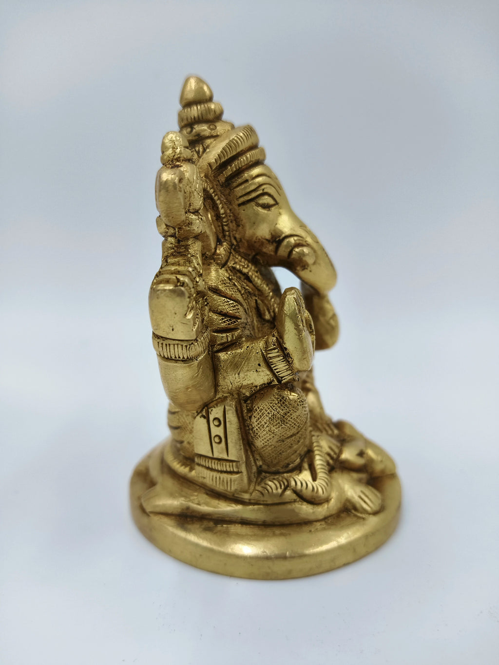 Small brass statue of sitting Lord Ganesha side view