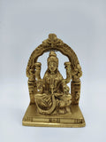 Small brass sculpture of Goddess Lakshmi seated on a lotus with arch frame