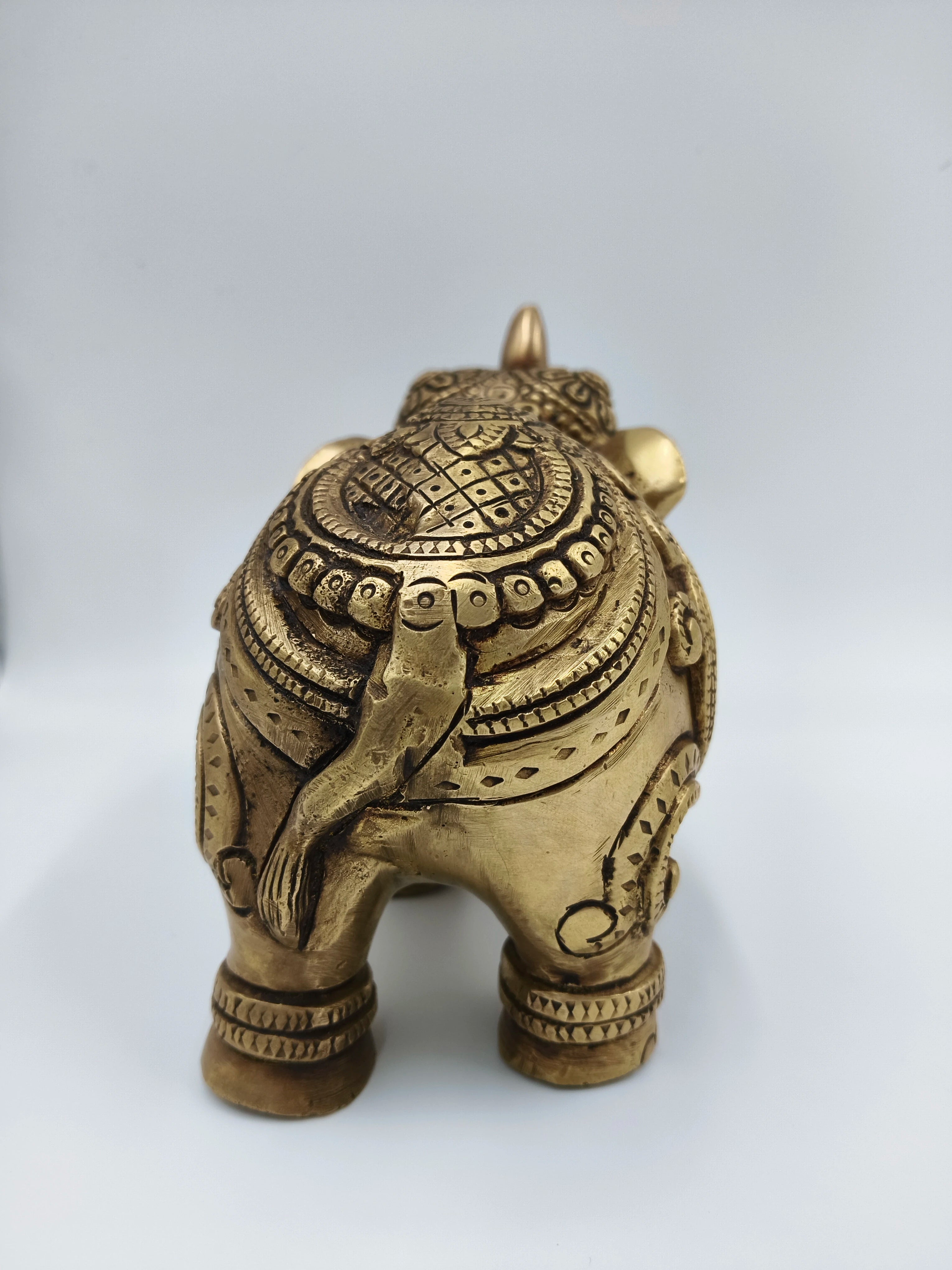 Rear view of medium-sized brass elephant figurine with detailed carvings