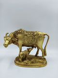 Large brass sculpture of cow and calf with floral patterns and blanket detailing