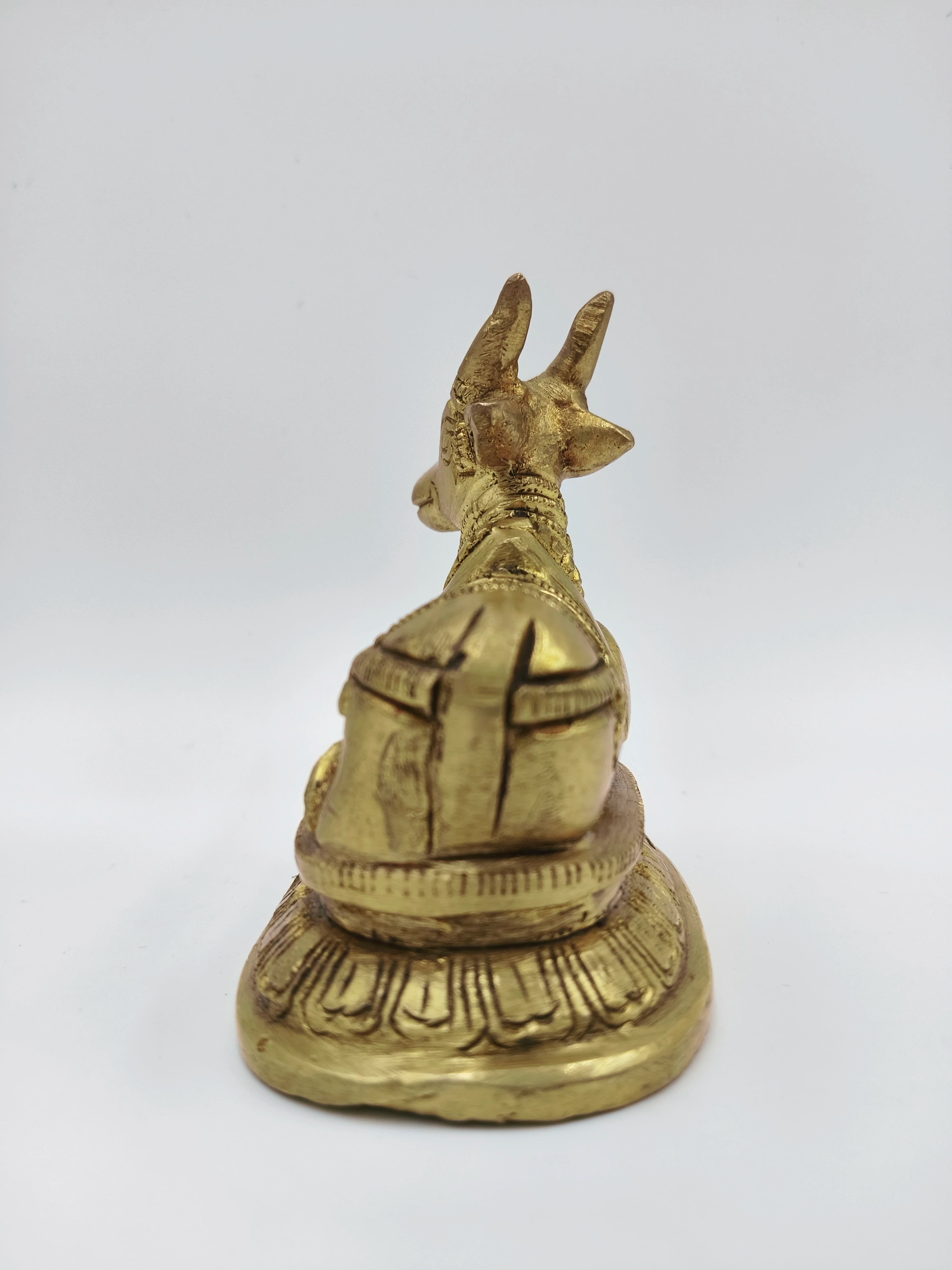 Small brass Nandi figurine sitting on decorated base, rear view